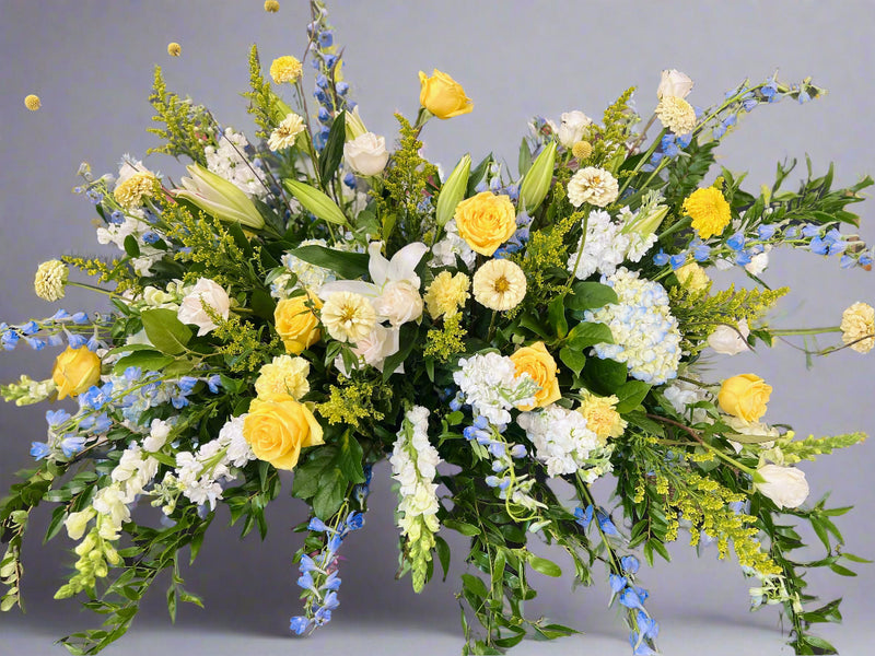 Serenity in Blue and Yellow Casket Spray